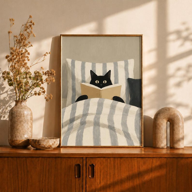 Black Cat Reading Book in Bed Wall Art Print, Cozy Morning Illustration with Striped Pillow and Soft Sunlight